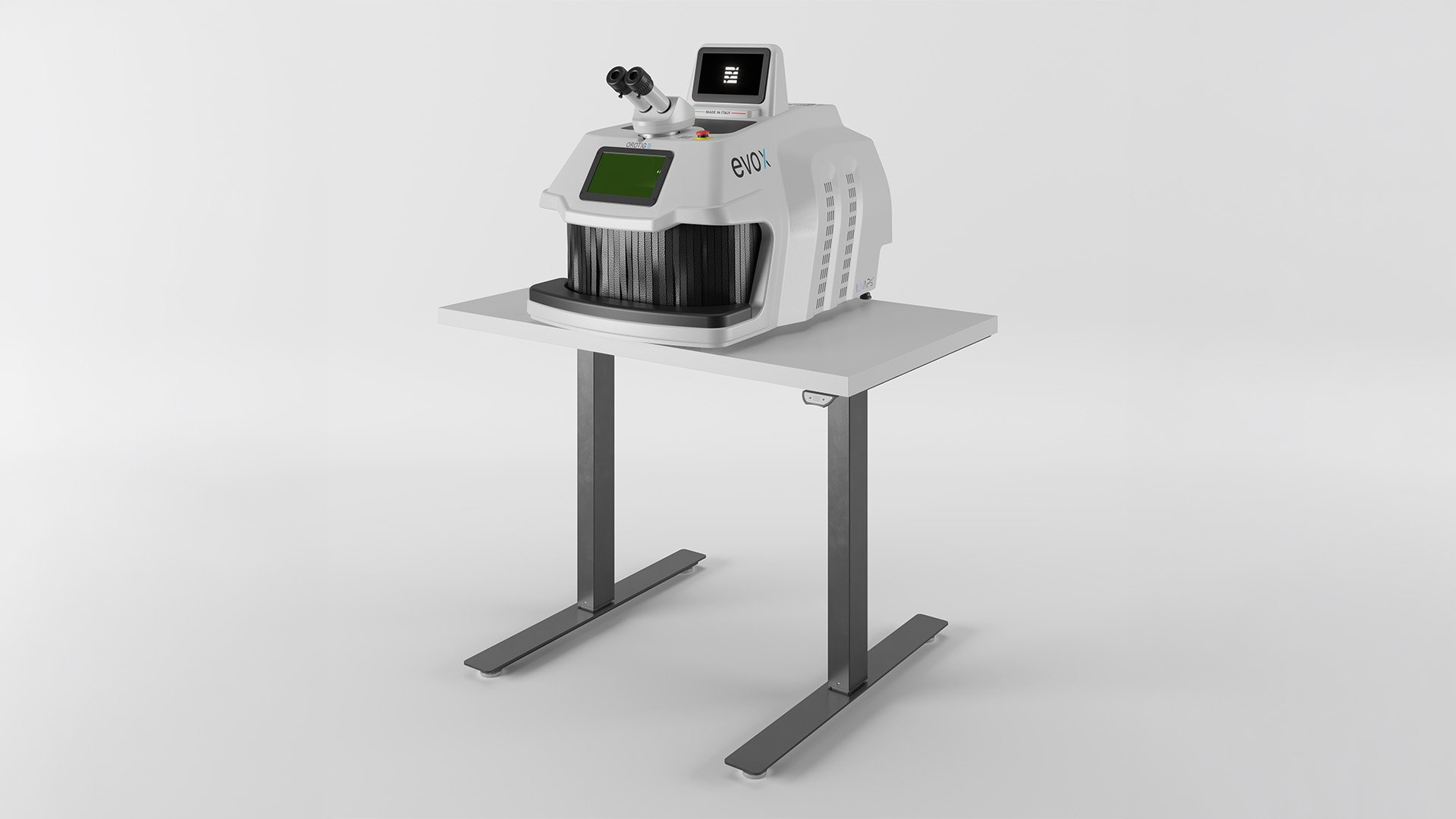 Side view of the Orotig Evo X laser welder positioned on an Orotig motorized adjustable-height table