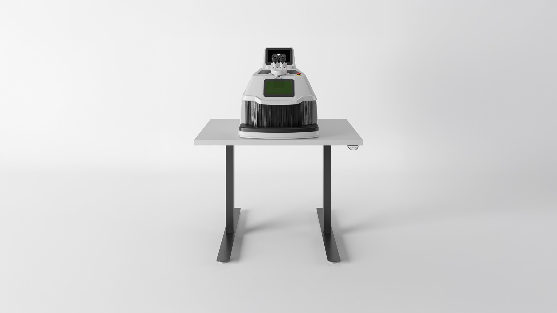 Vista frontale della saldatrice laser Orotig Evo X, posizionata su tavolino motorizzato Orotig regolabile in altezza